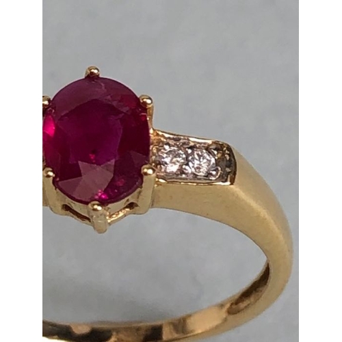 45 - 14ct Gold ring set with Oval faceted Ruby in claw setting with pair of diamonds to each shoulder siz... 