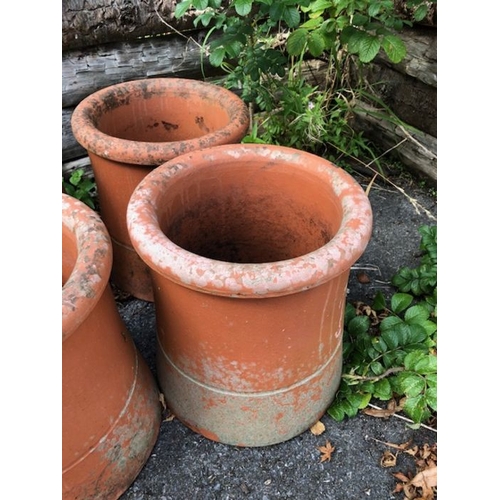 451 - Collection of four matching chimney pots each approx 30cm tall