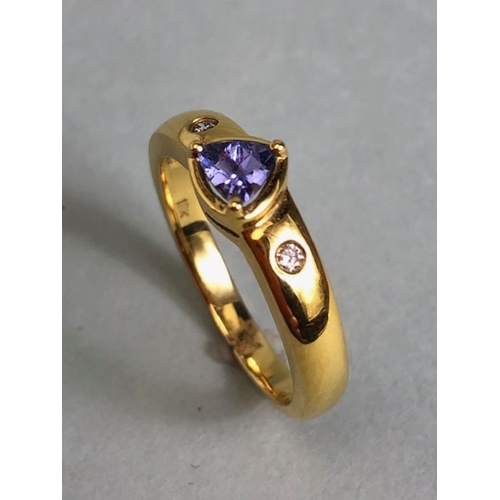 53 - 18ct Gold ring set with Triangular faceted Tanzanite stone with diamond shoulders size approx 'O' an... 