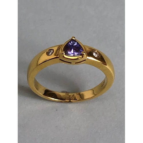 53 - 18ct Gold ring set with Triangular faceted Tanzanite stone with diamond shoulders size approx 'O' an... 