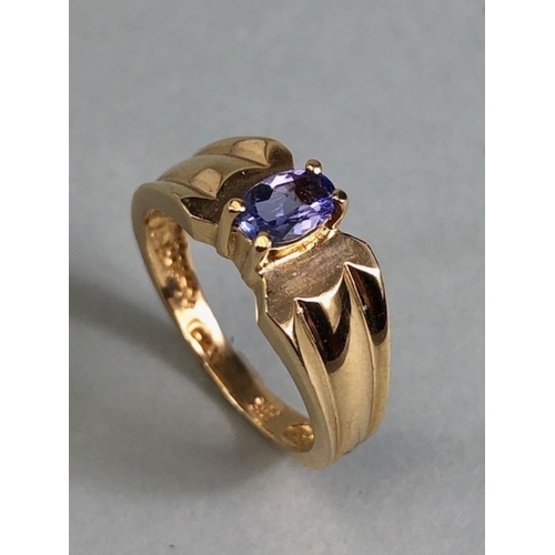 65 - 14ct Gold contemporary ring set with a Oval Tanzanite (approx 6mm x 4mm) in four claw setting size a... 