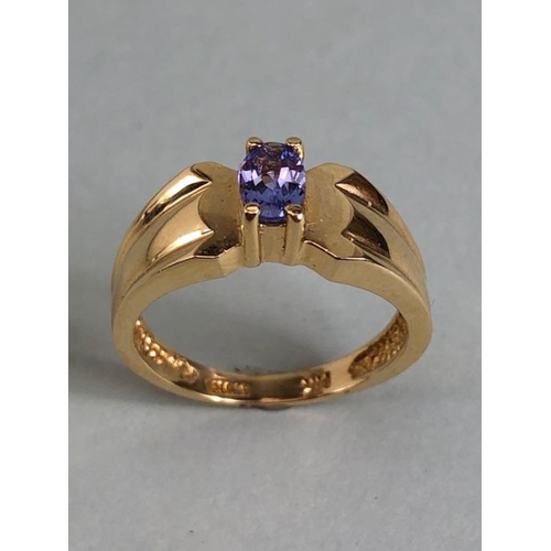 65 - 14ct Gold contemporary ring set with a Oval Tanzanite (approx 6mm x 4mm) in four claw setting size a... 