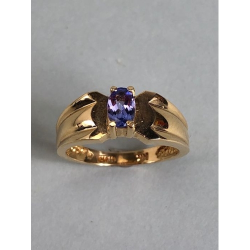 65 - 14ct Gold contemporary ring set with a Oval Tanzanite (approx 6mm x 4mm) in four claw setting size a... 