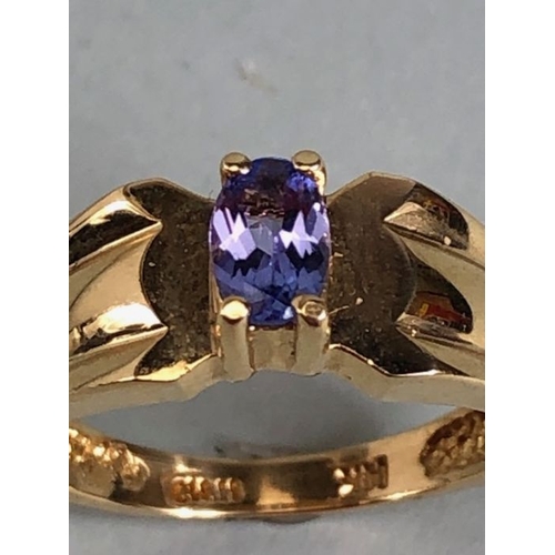 65 - 14ct Gold contemporary ring set with a Oval Tanzanite (approx 6mm x 4mm) in four claw setting size a... 