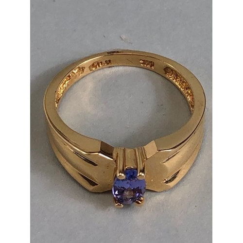 65 - 14ct Gold contemporary ring set with a Oval Tanzanite (approx 6mm x 4mm) in four claw setting size a... 