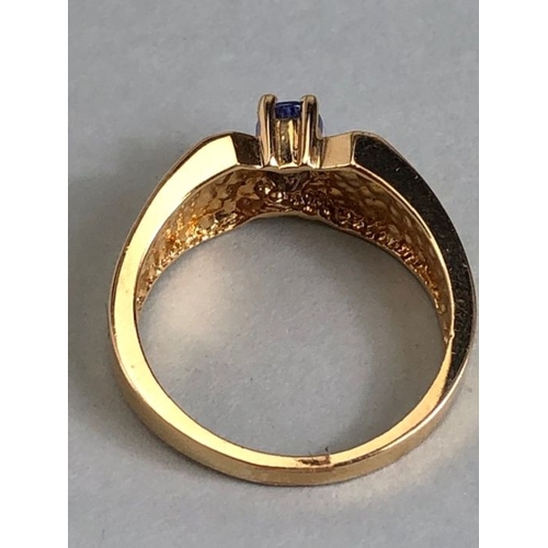 65 - 14ct Gold contemporary ring set with a Oval Tanzanite (approx 6mm x 4mm) in four claw setting size a... 