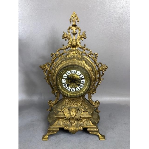 107A - Antique Clock, Louis style elaborately decorated brass cased mantel clock with Roman numeral dial, a... 