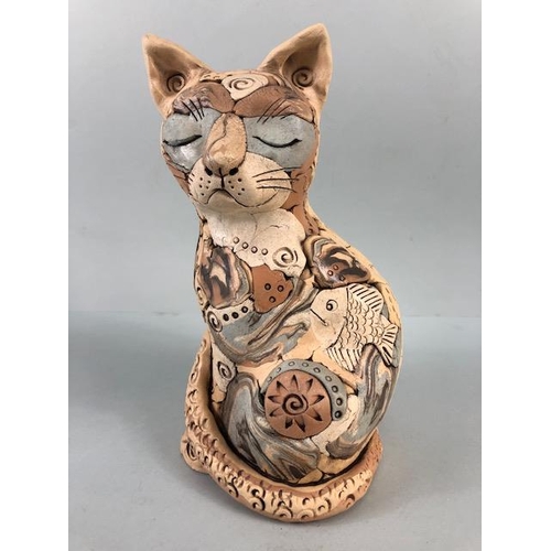 152 - Studio Pottery, multi colour jigsaw pottery figure of a content cat with a fish, matt glaze finish a... 