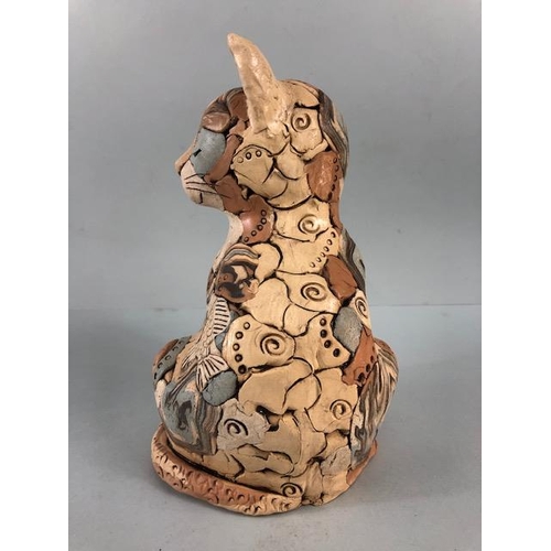 152 - Studio Pottery, multi colour jigsaw pottery figure of a content cat with a fish, matt glaze finish a... 