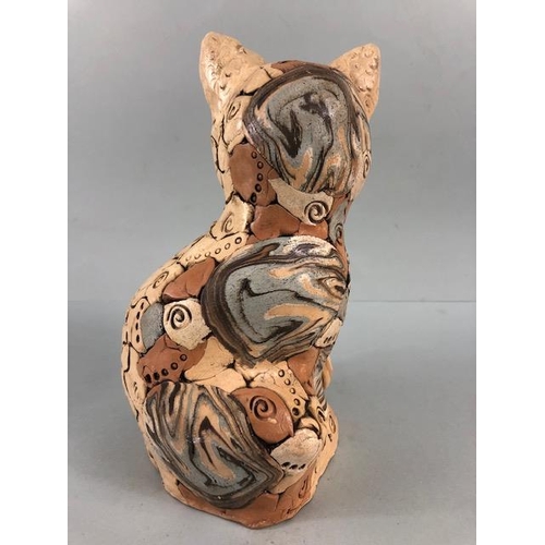 152 - Studio Pottery, multi colour jigsaw pottery figure of a content cat with a fish, matt glaze finish a... 