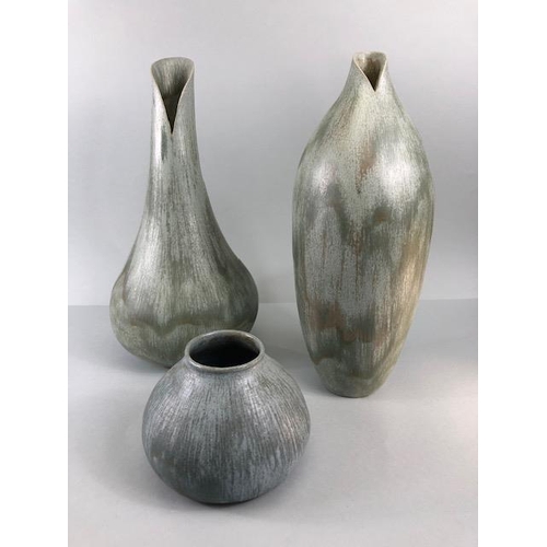 157 - Studio pottery, Art ceramics, Three stoneware vases of organic form with matching Viridian green mat... 