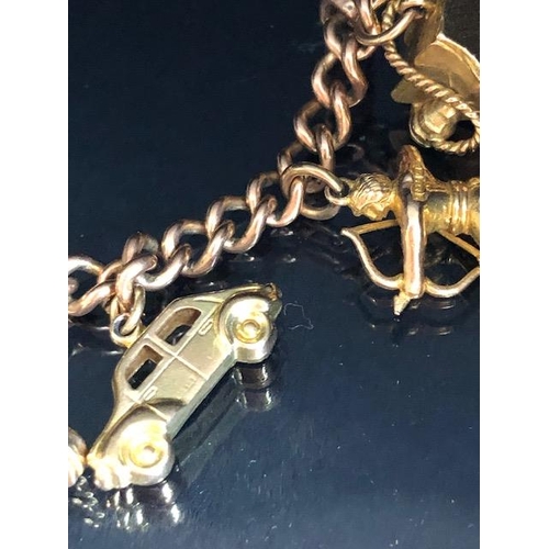 2 - 9ct Gold Charm Bracelet with approx seventeen charms to include Cupid, a British Passport, Archer, c... 