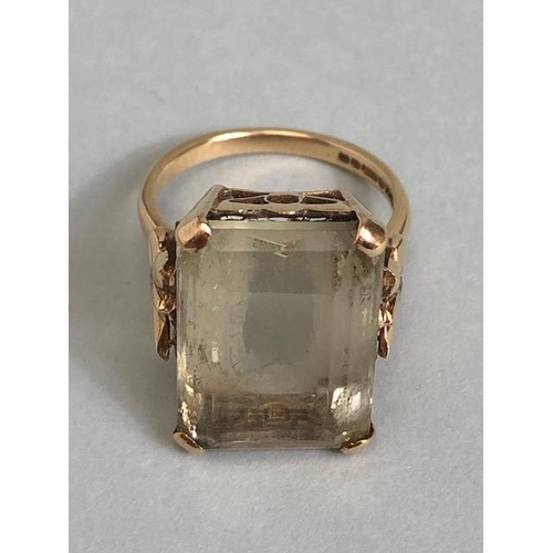 25A - 9ct yellow gold ring mounted with a pale quartz  Emerald cut stone the shoulders of butterfly design... 