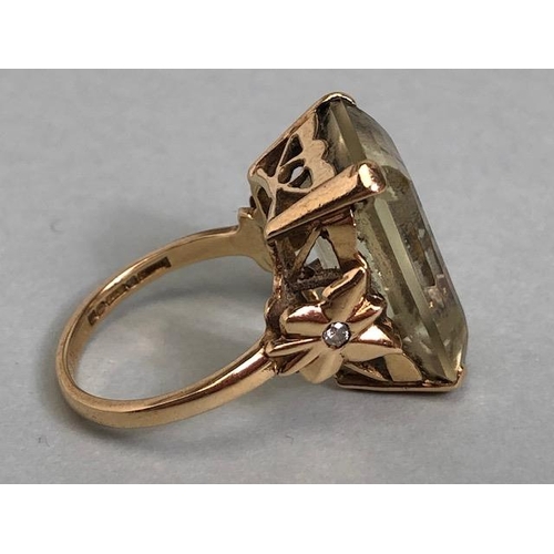 25A - 9ct yellow gold ring mounted with a pale quartz  Emerald cut stone the shoulders of butterfly design... 