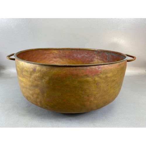 315 - Copper Pan, large deep hand planished copper pan with twin brass handles approximately 44cm across