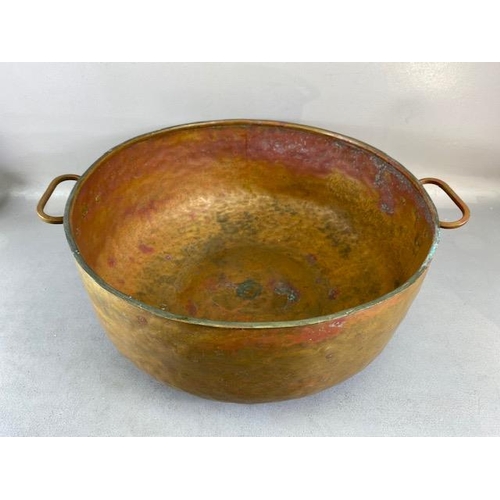 315 - Copper Pan, large deep hand planished copper pan with twin brass handles approximately 44cm across