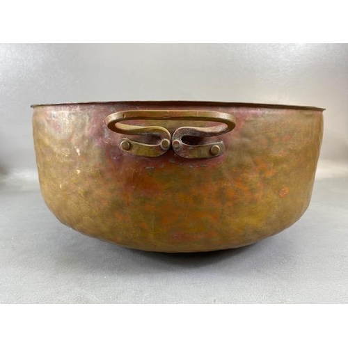 315 - Copper Pan, large deep hand planished copper pan with twin brass handles approximately 44cm across