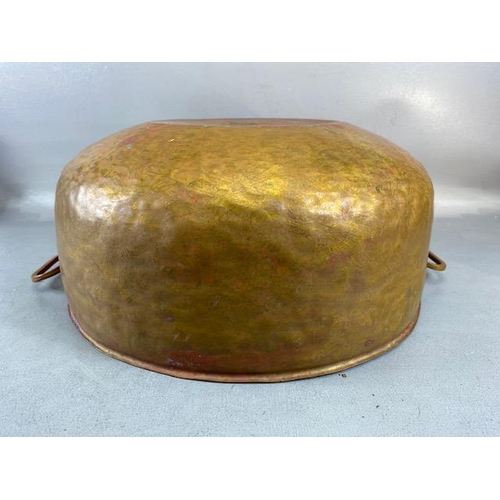 315 - Copper Pan, large deep hand planished copper pan with twin brass handles approximately 44cm across