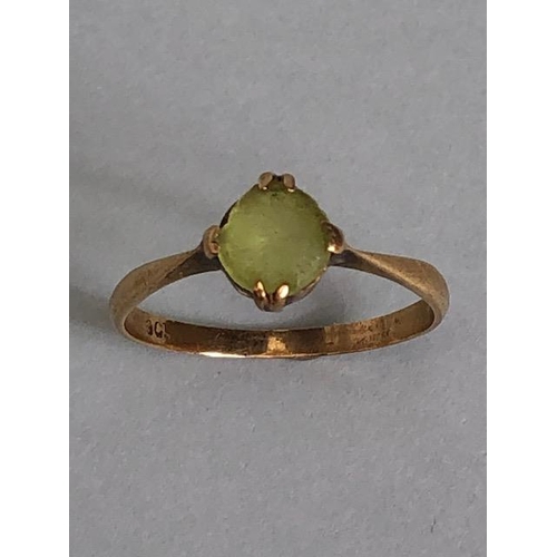 38A - 9ct marked  yellow gold ring set with a pale green stone approximately 1.59g size O 1/2