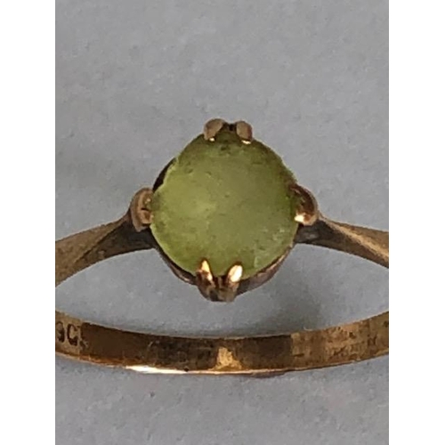 38A - 9ct marked  yellow gold ring set with a pale green stone approximately 1.59g size O 1/2