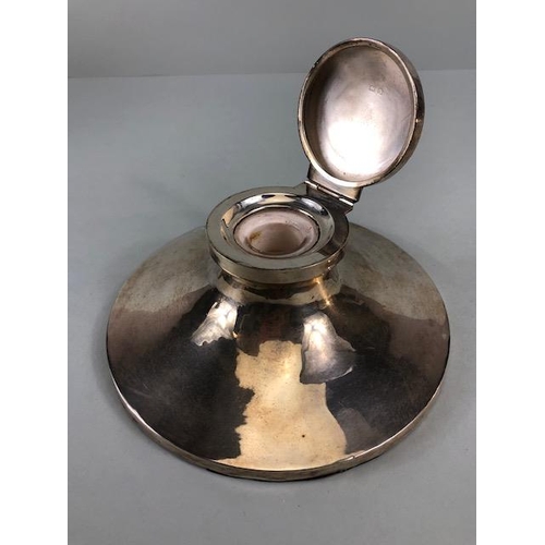 50 - Silver hallmarked large circular based ink well with hinged lid and glass inset, the filled base app... 