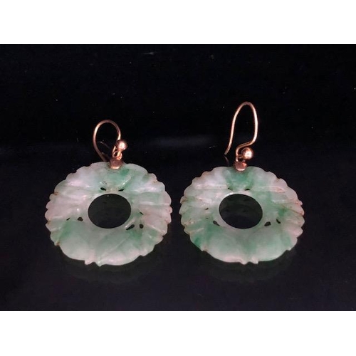 58 - Pair of circular Jade earrings each approx 24mm in diameter and on gold coloured wire possibly Chine... 