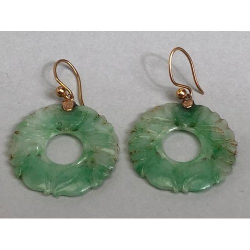 58 - Pair of circular Jade earrings each approx 24mm in diameter and on gold coloured wire possibly Chine... 