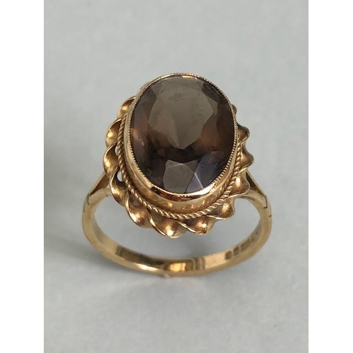 61a - 9ct Gold ring set with a smokey Quartz gemstone approx 13mm x 9mm and size 'L'