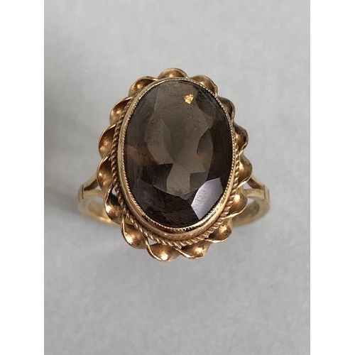 61a - 9ct Gold ring set with a smokey Quartz gemstone approx 13mm x 9mm and size 'L'