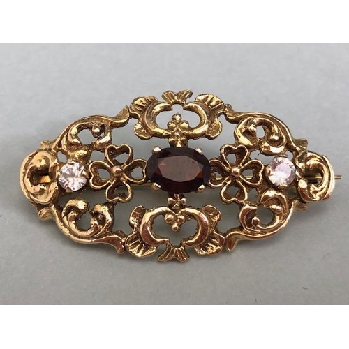 62a - 9ct Gold pierced brooch set with gemstones of a Victorian style approx 35mm x 20mm & 4.4g