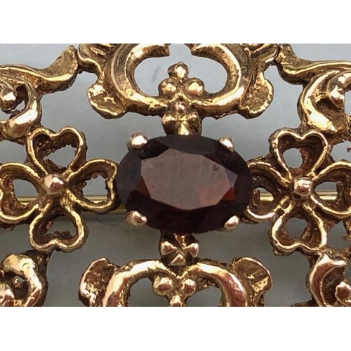 62a - 9ct Gold pierced brooch set with gemstones of a Victorian style approx 35mm x 20mm & 4.4g