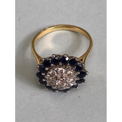 64a - 18ct yellow gold Diamond and Sapphire Daisy style ring. A central diamond surrounded by a ring of ei... 