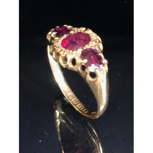 65a - 18ct Gold ring set with diamonds and red/ pink gemstones size 'O' and 3g