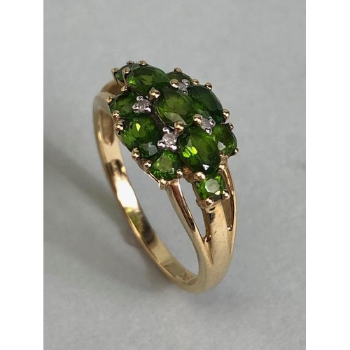 68 - 9ct Gold ring set with green Tourmaline gemstones with pierced shoulders size approx 'M'