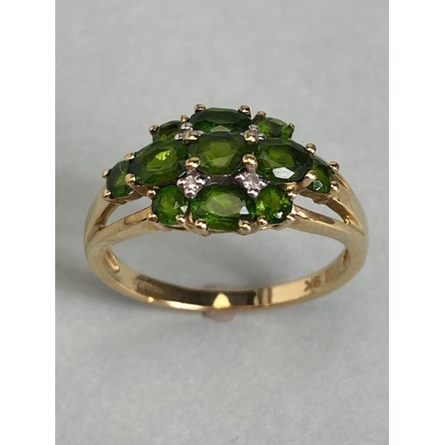 68 - 9ct Gold ring set with green Tourmaline gemstones with pierced shoulders size approx 'M'