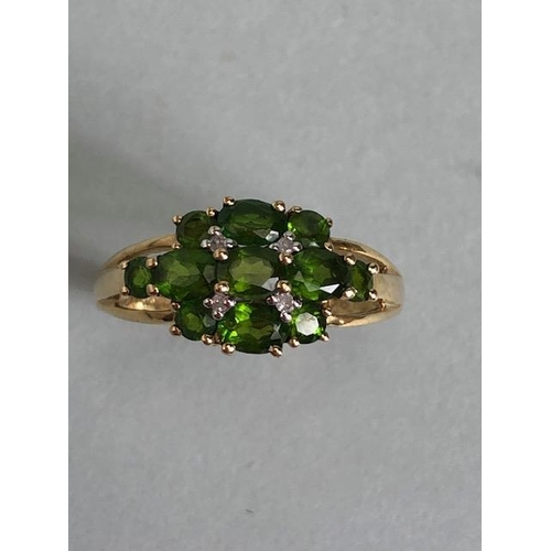 68 - 9ct Gold ring set with green Tourmaline gemstones with pierced shoulders size approx 'M'