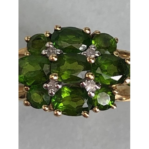 68 - 9ct Gold ring set with green Tourmaline gemstones with pierced shoulders size approx 'M'