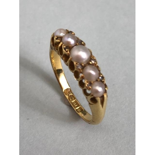 68a - 18ct Gold ring set with five graduated pearls and divided by pairs of small diamonds size approx 'M'... 