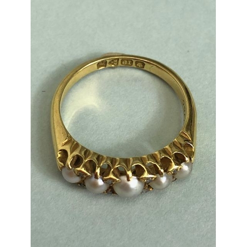 68a - 18ct Gold ring set with five graduated pearls and divided by pairs of small diamonds size approx 'M'... 