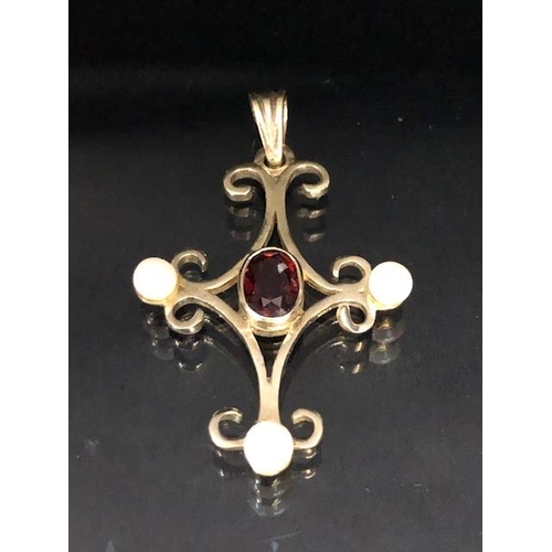 70 - 9ct gold pendant in the form of a cross and set with pearls and a central oval garnet approx 3.5 x 2... 