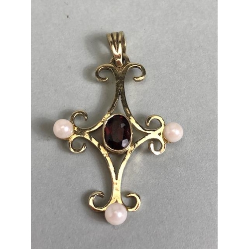 70 - 9ct gold pendant in the form of a cross and set with pearls and a central oval garnet approx 3.5 x 2... 