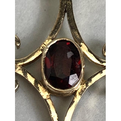 70 - 9ct gold pendant in the form of a cross and set with pearls and a central oval garnet approx 3.5 x 2... 