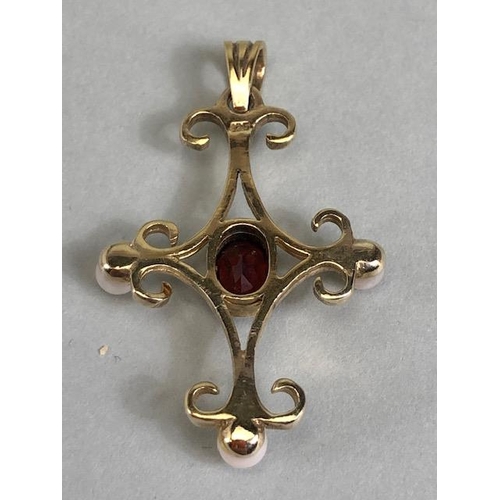 70 - 9ct gold pendant in the form of a cross and set with pearls and a central oval garnet approx 3.5 x 2... 