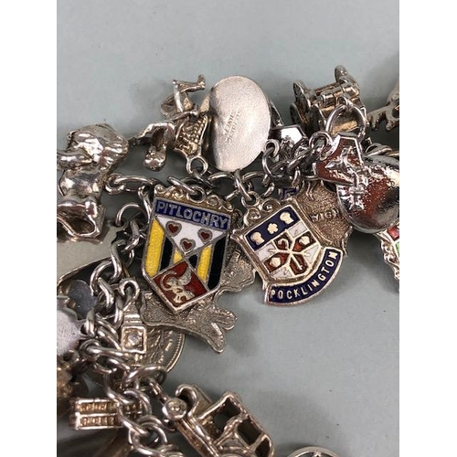 79 - Silver 925 charm bracelet with approximately 42 charms, some of unusual design, London taxi ,Radiogr... 