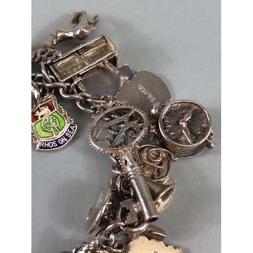 79 - Silver 925 charm bracelet with approximately 42 charms, some of unusual design, London taxi ,Radiogr... 