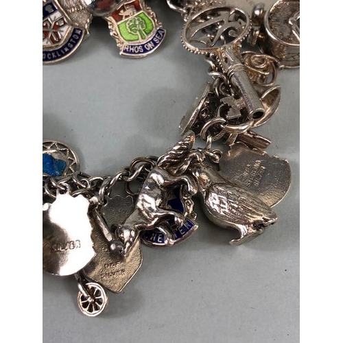 79 - Silver 925 charm bracelet with approximately 42 charms, some of unusual design, London taxi ,Radiogr... 