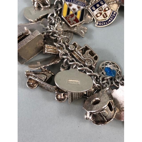 79 - Silver 925 charm bracelet with approximately 42 charms, some of unusual design, London taxi ,Radiogr... 