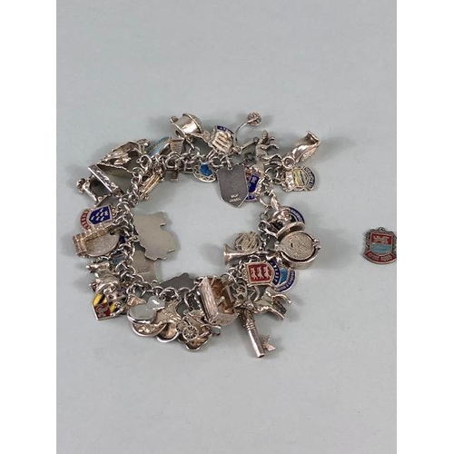 79 - Silver 925 charm bracelet with approximately 42 charms, some of unusual design, London taxi ,Radiogr... 