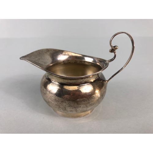 9 - Silver hallmarked creamer on pedestal base with rounded body and scroll handle maker T.W approx 48g