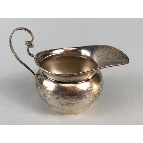 9 - Silver hallmarked creamer on pedestal base with rounded body and scroll handle maker T.W approx 48g